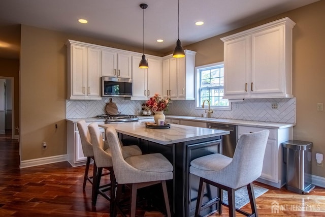 29 Mitchell Dr, Monroe, NJ 08831 - kitchen featuring stainless steel appliances, dark wood finished floors, white cabinets, a breakfast bar, and a center island