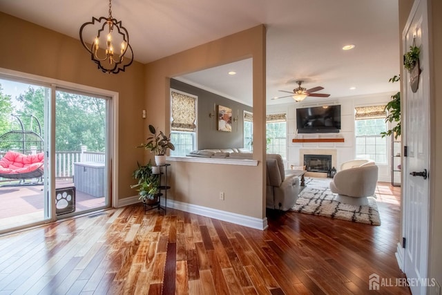 29 Mitchell Dr, Monroe, NJ 08831 - kitchen featuring a glass covered fireplace, ceiling fan, wood finished floors, a chandelier, and crown molding