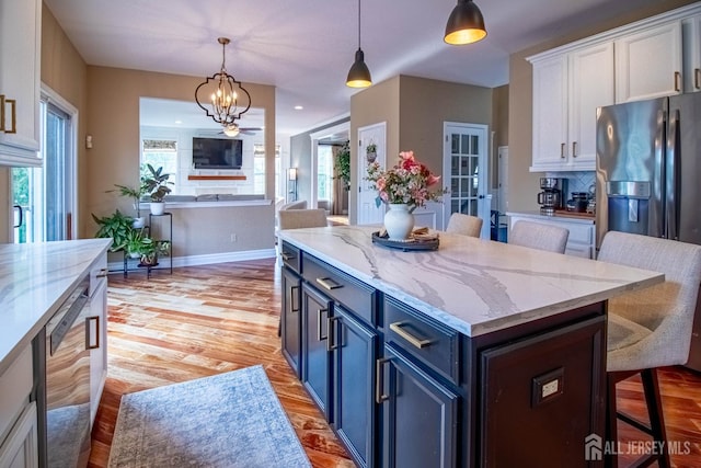 29 Mitchell Dr, Monroe, NJ 08831 - kitchen with white cabinetry, a kitchen bar, light wood finished floors, pendant lighting, and open floor plan