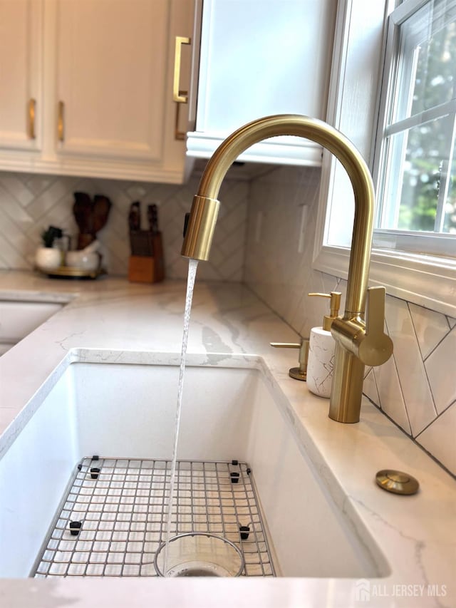 29 Mitchell Dr, Monroe, NJ 08831 - kitchen view of tasteful backsplash, white cabinetry, and light stone countertops