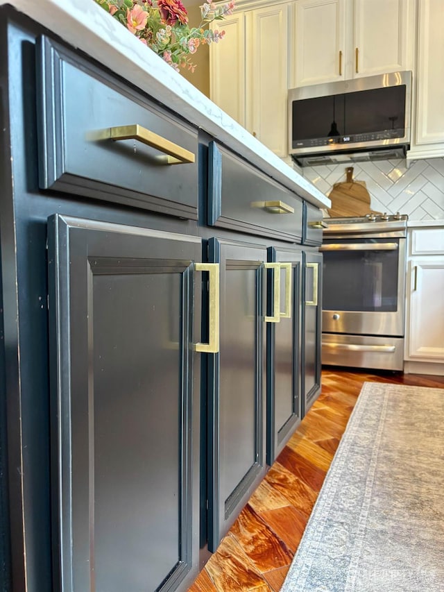 29 Mitchell Dr, Monroe, NJ 08831 - kitchen with stainless steel appliances, light wood-style flooring, light countertops, tasteful backsplash, and white cabinets
