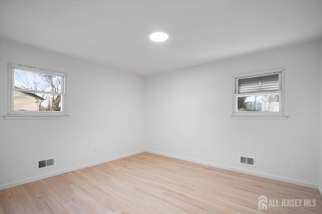 unfurnished room featuring light hardwood / wood-style floors