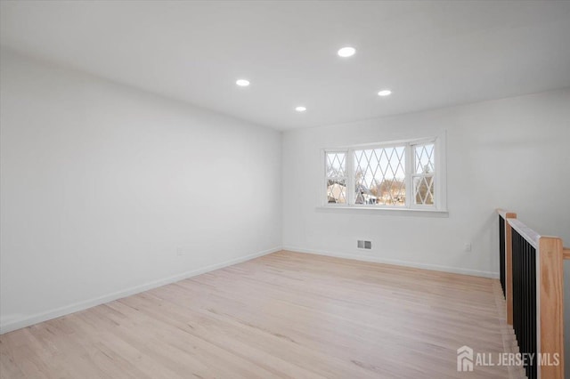 spare room featuring light hardwood / wood-style floors