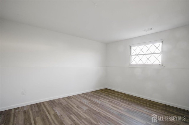 empty room with hardwood / wood-style flooring