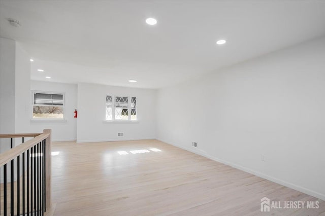 spare room featuring light hardwood / wood-style flooring