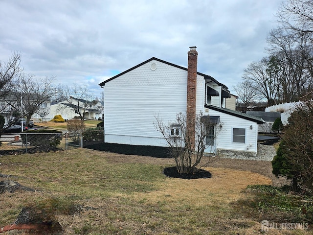 view of side of property with a lawn