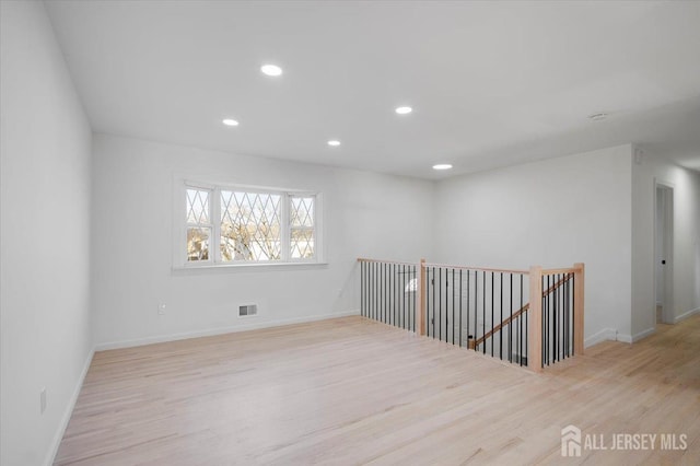 unfurnished room featuring light hardwood / wood-style flooring