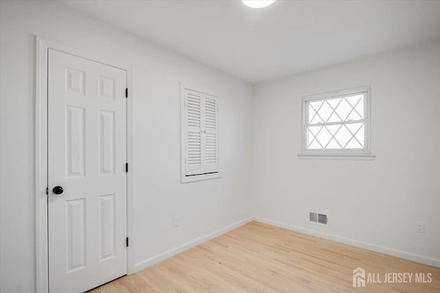 empty room with light wood-type flooring