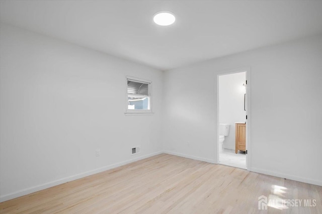 spare room featuring light wood-type flooring