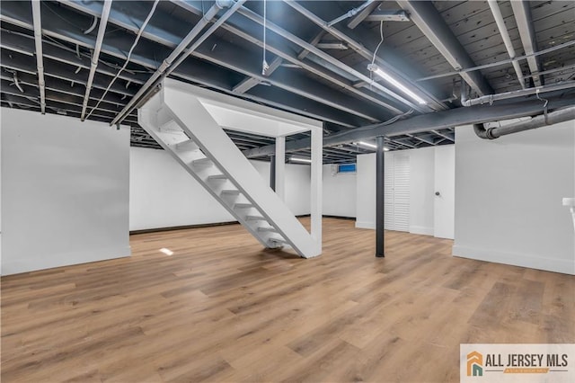 8 1st St, Sayreville, NJ 08872 - finished basement with stairs, wood finished floors, and baseboards
