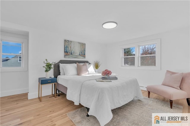 8 1st St, Sayreville, NJ 08872 - bedroom with multiple windows, light wood-type flooring, and baseboards