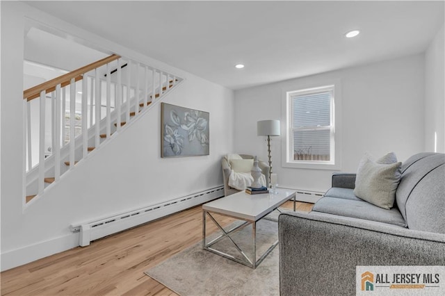 8 1st St, Sayreville, NJ 08872 - living area with a baseboard heating unit, wood finished floors, stairs, and recessed lighting