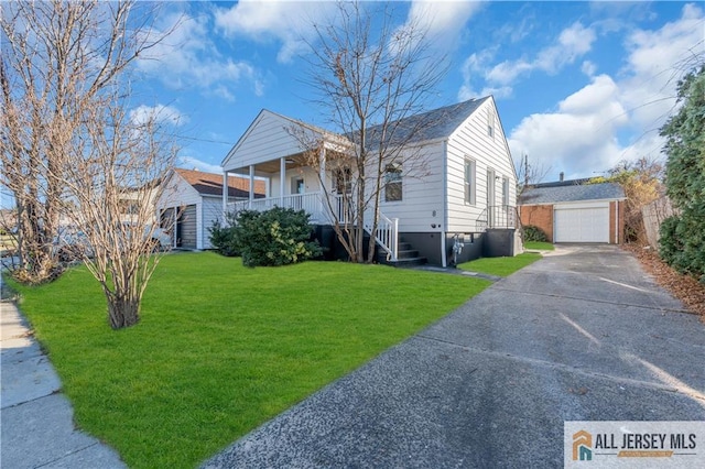 8 1st St, Sayreville, NJ 08872 - view of front of house with an outbuilding, driveway, covered porch, a front yard, and a detached garage