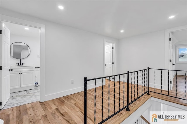 8 1st St, Sayreville, NJ 08872 - corridor featuring an upstairs landing, recessed lighting, baseboards, and a sink
