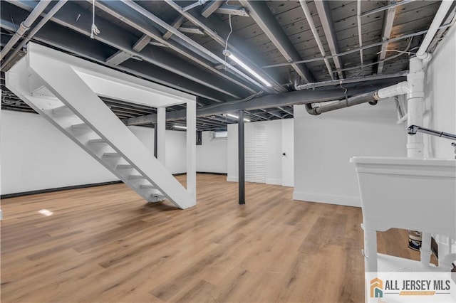 8 1st St, Sayreville, NJ 08872 - finished below grade area with wood finished floors, stairway, and baseboards