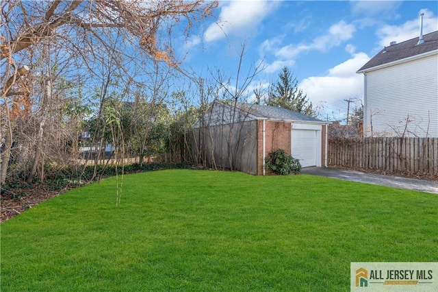 8 1st St, Sayreville, NJ 08872 - view of yard with asphalt driveway, an outbuilding, and a detached garage