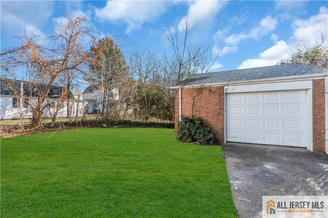8 1st St, Sayreville, NJ 08872 - view of grassy yard featuring asphalt driveway, a garage, and an outdoor structure