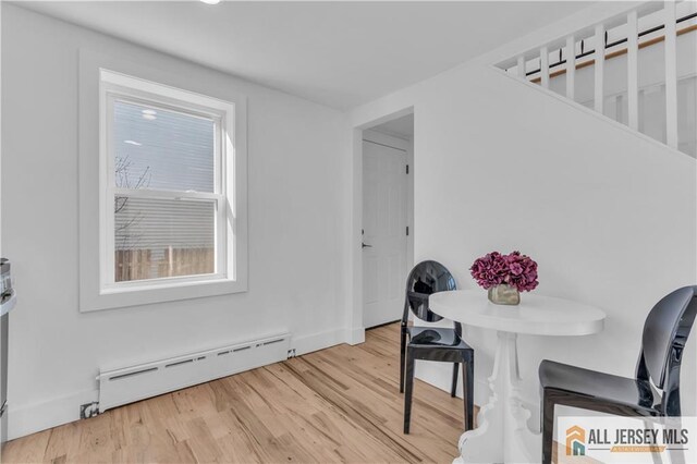 8 1st St, Sayreville, NJ 08872 - dining room with a baseboard heating unit and light wood-style floors