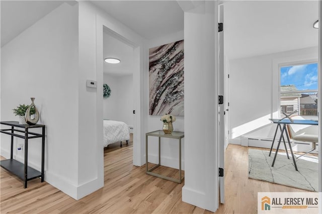 8 1st St, Sayreville, NJ 08872 - hall featuring light wood-style flooring, a baseboard radiator, and baseboards