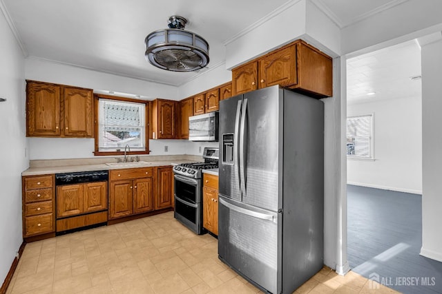 kitchen featuring sink, stainless steel appliances, and crown molding