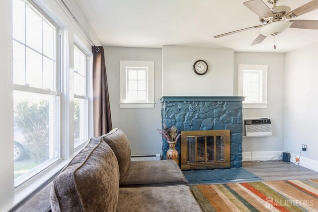 1427 Myrtle Ave, Plainfield, NJ 07063 - living area with a wall unit AC, baseboard heating, plenty of natural light, and ceiling fan