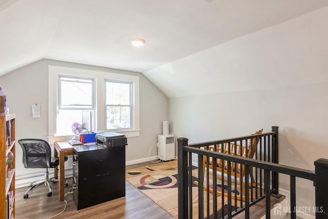 office area featuring baseboards, lofted ceiling, and light wood-style floors