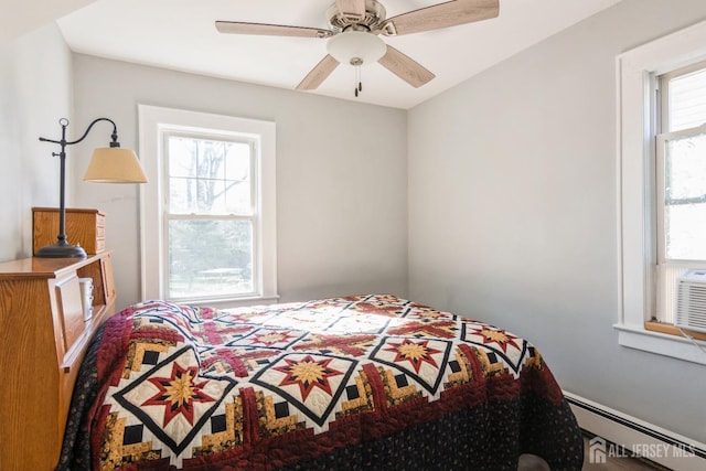 bedroom featuring a baseboard heating unit and ceiling fan