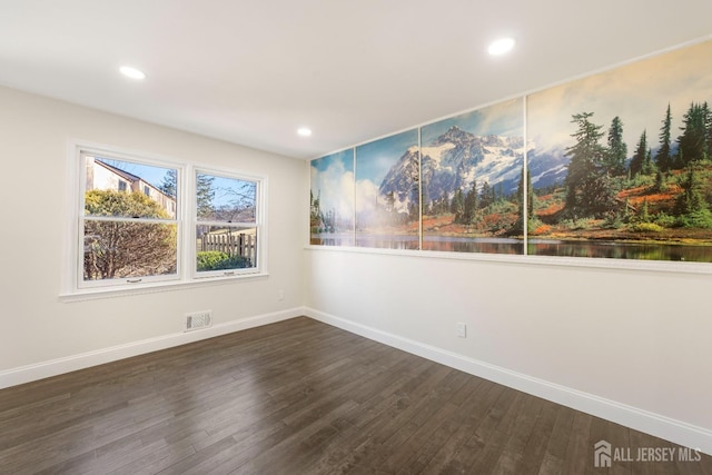 unfurnished room featuring dark hardwood / wood-style flooring