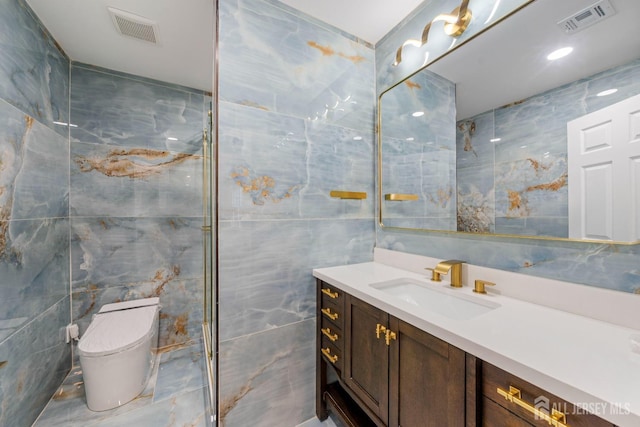 bathroom featuring tile walls, vanity, and toilet