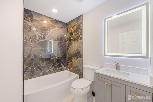 full bathroom featuring tiled shower / bath combo, vanity, and toilet