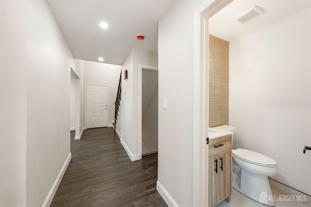 hallway with dark hardwood / wood-style floors