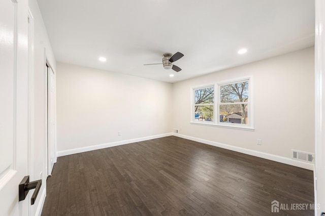 unfurnished bedroom featuring dark hardwood / wood-style floors and ceiling fan