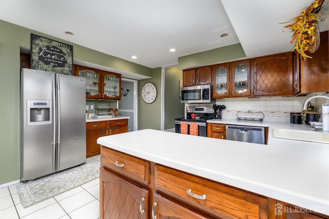 3 Romero Ct, Monroe, NJ 08831 - kitchen featuring stainless steel appliances, a sink, glass insert cabinets, backsplash, and light countertops