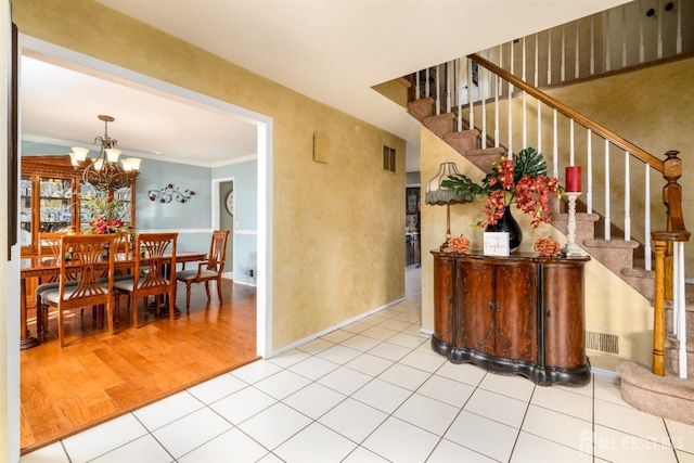 3 Romero Ct, Monroe, NJ 08831 - foyer entrance featuring stairway, a chandelier, baseboards, tile patterned floors, and crown molding