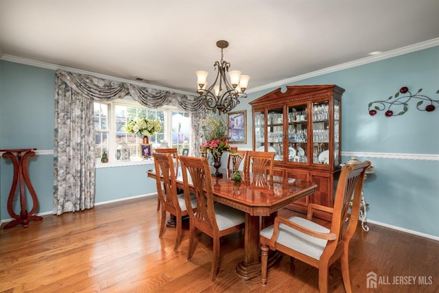 3 Romero Ct, Monroe, NJ 08831 - dining space with a chandelier, crown molding, wood finished floors, and baseboards