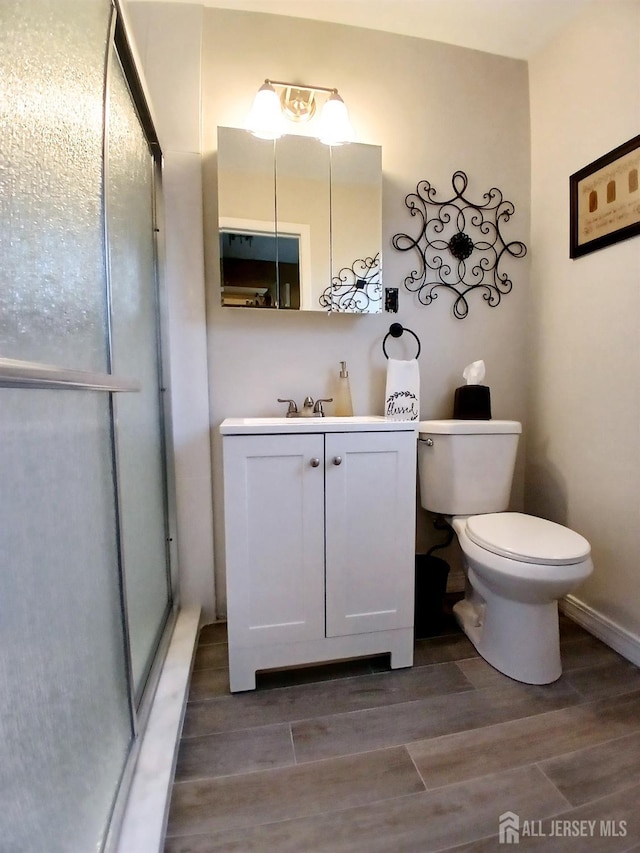 3 Romero Ct, Monroe, NJ 08831 - bathroom with wood finished floors, toilet, a shower stall, and vanity