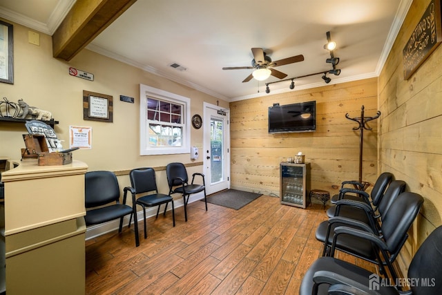 3 Romero Ct, Monroe, NJ 08831 - living area featuring track lighting, ceiling fan, wood finished floors, wine cooler, and wood walls