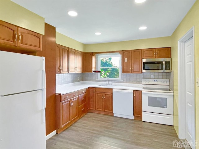 15 Race Track Rd, East Brunswick, NJ 08816 - kitchen with white appliances, brown cabinets, light wood-style floors, light countertops, and recessed lighting
