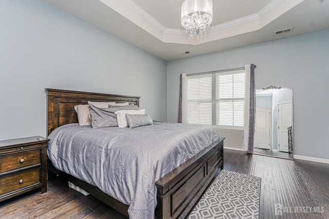 606 Bayside Ct, South Amboy, NJ 08879 - bedroom featuring a chandelier, dark wood-style floors, a raised ceiling, ornamental molding, and baseboards