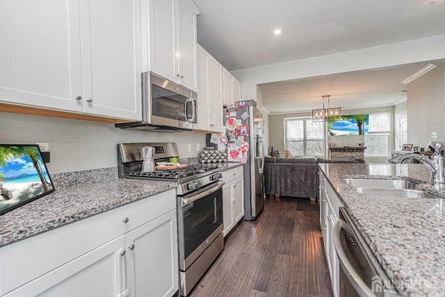 606 Bayside Ct, South Amboy, NJ 08879 - kitchen with stainless steel appliances, a sink, crown molding, dark wood-style flooring, and white cabinets
