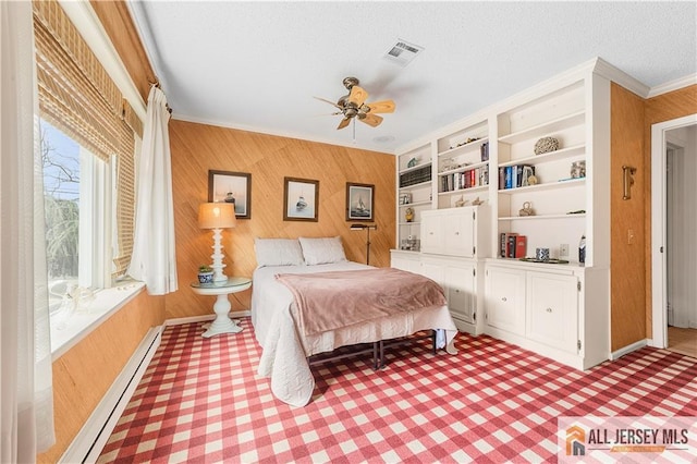 bedroom with visible vents, a textured ceiling, a baseboard heating unit, crown molding, and light carpet