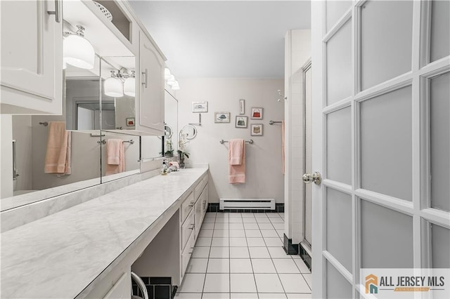 bathroom featuring tile patterned floors, vanity, and a baseboard radiator