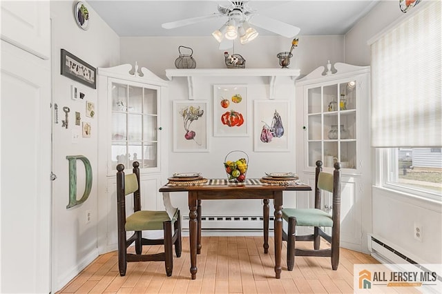 dining room featuring light wood-style flooring, a baseboard heating unit, ceiling fan, and a baseboard radiator