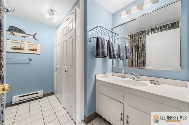 bathroom featuring tile patterned floors, a baseboard radiator, baseboards, and vanity