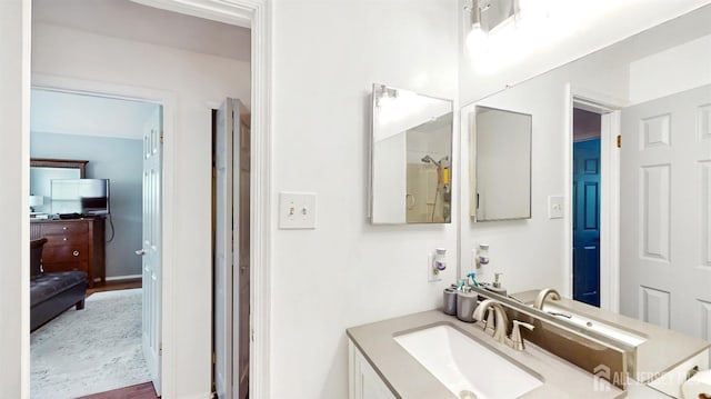 bathroom with wood finished floors and vanity