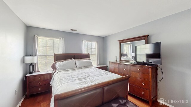 28 Clay St, North Brunswick, NJ 08902 - bedroom with baseboards, dark wood-style floors, and visible vents