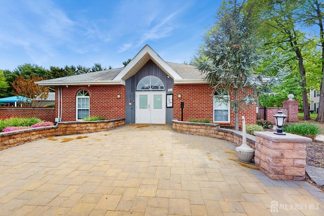 ranch-style house with french doors and brick siding