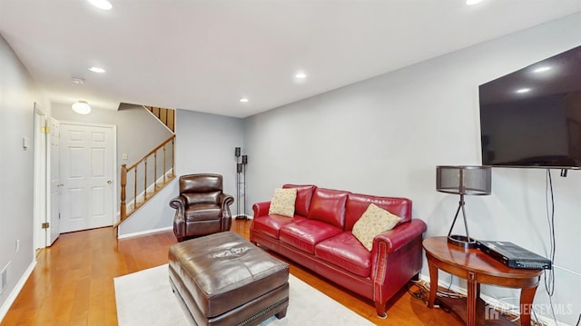 living area featuring stairway, recessed lighting, and wood finished floors