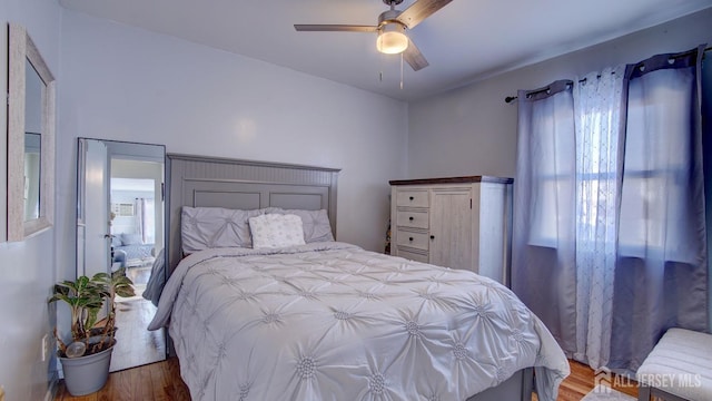 bedroom featuring hardwood / wood-style floors and ceiling fan