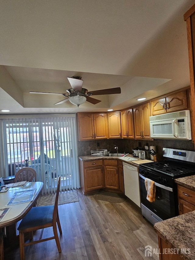 362 Minstrel Ct Unit 362, Old Bridge, NJ 08857 - kitchen with white appliances, dark wood-style floors, ceiling fan, decorative backsplash, and a raised ceiling
